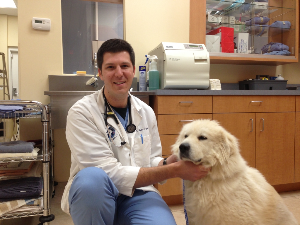 Dr. Fritz J. Trybus and dog sitting in veterinary practice