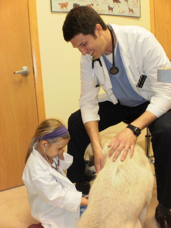 Dr. Trybus and kid examining a patient